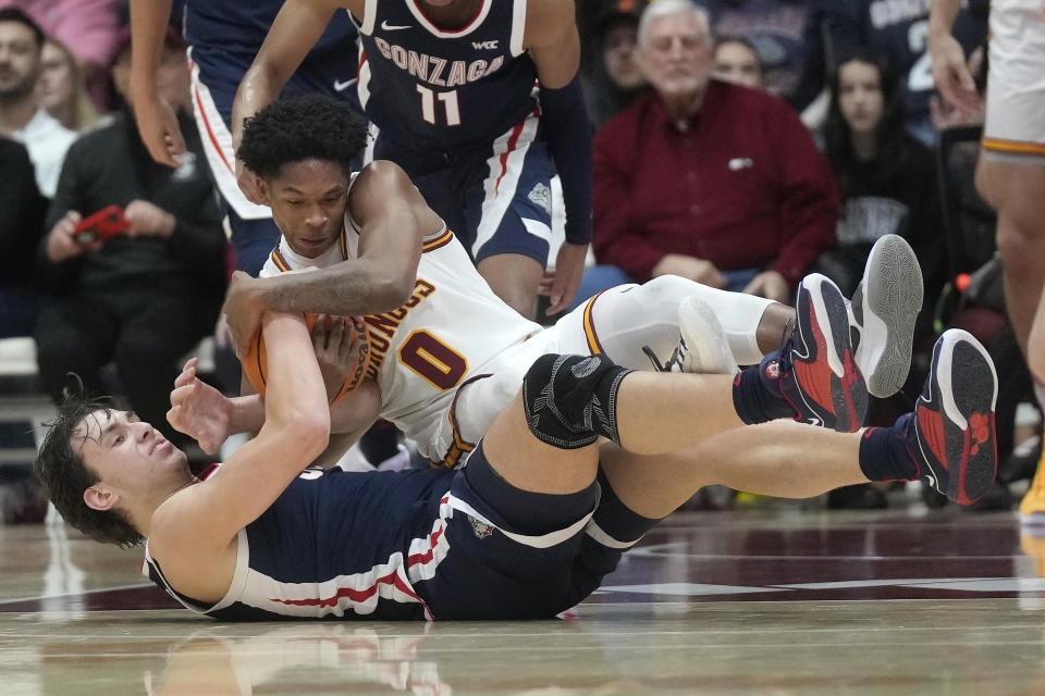 Santa Clara guard Brenton Knapper (0) wrestles for the ball with Gonzaga forward Braden Huff during the second half of an NCAA college basketball game in Santa Clara, Calif., Thursday, Jan. 11, 2024. (AP Photo/Jeff Chiu)