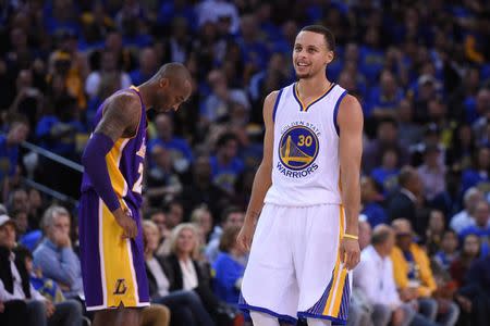 November 1, 2014; Oakland, CA, USA; Golden State Warriors guard Stephen Curry (30) smiles in front of Los Angeles Lakers guard Kobe Bryant (24) during the second quarter at Oracle Arena. Mandatory Credit: Kyle Terada-USA TODAY Sports