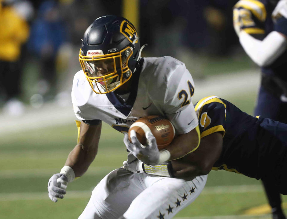 Moeller running back Jordan Marshall scores a  touchdown during their playoff game against Springfield, Friday, Nov. 26, 2021.