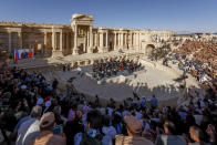 FILE - This photo provided by Russian Defense Ministry Press Service, shows the concert at the UNESCO world heritage site of Palmyra, the central city of Homs, where renowned conductor Valery Gergiev leads a performance by the Mariinsky Symphony Orchestra from St. Petersburg, Syria, May 5, 2016. Political observers say Russia’s brazen Syria intervention emboldened Putin, giving him a renewed Middle East foothold and helped pave the way for his current attack on Ukraine. (Olga Balashova/Russian Defense Ministry Press Service via AP, File)