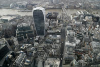 A view over the City of London taken from the 59th floor of 22 Bishopsgate in London, Thursday, April 1, 2021. When the pandemic struck, about 540,000 workers vanished from London's financial hub almost overnight. The area known as "the City" became a ghost town as many people began working from home. A year on, most haven't returned to the business hub. While many people believe that post-pandemic workflow will become the new normal, skyscrapers are still rising, and city planners say they aren't worried about empty office blocks. (AP Photo/Alastair Grant)