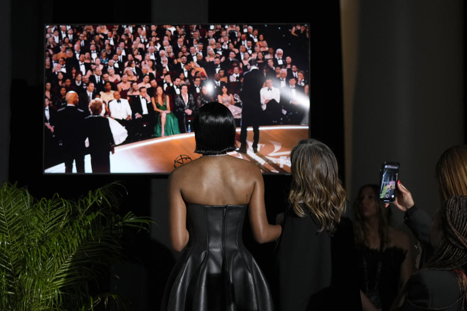 Ayo Edebiri, winner of the award for outstanding supporting actress in a comedy series for "The Bear," watches the show from inside the press room during the 75th Primetime Emmy Awards on Monday, Jan. 15, 2024, at the Peacock Theater in Los Angeles. (AP Photo/Ashley Landis)