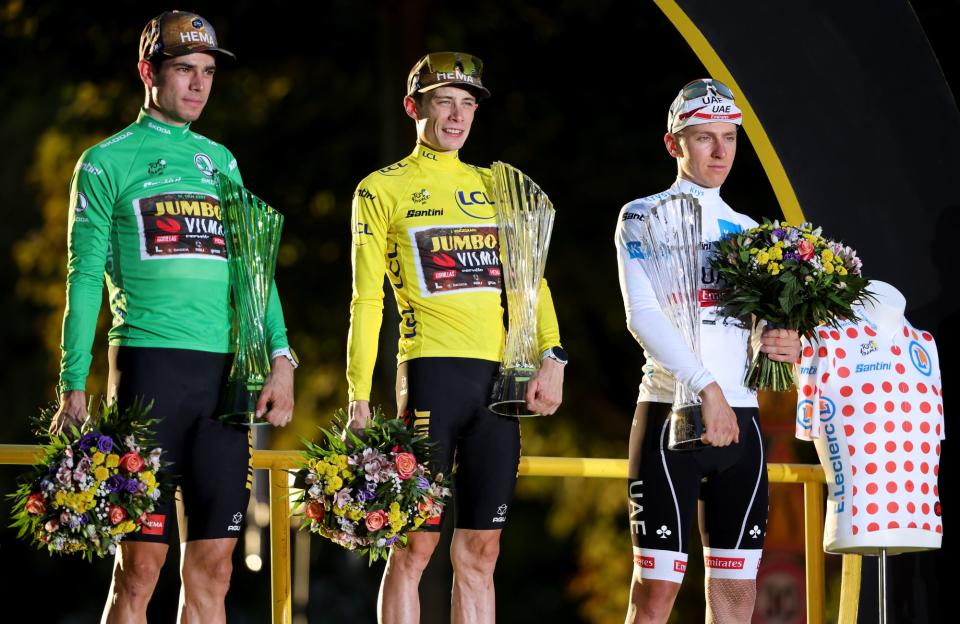 Wout van Aert in the green jersey, Joas Vingegaard in the yellow jersey, and Tadej Pogacar in the white jersey at the 2022 Tour de France.