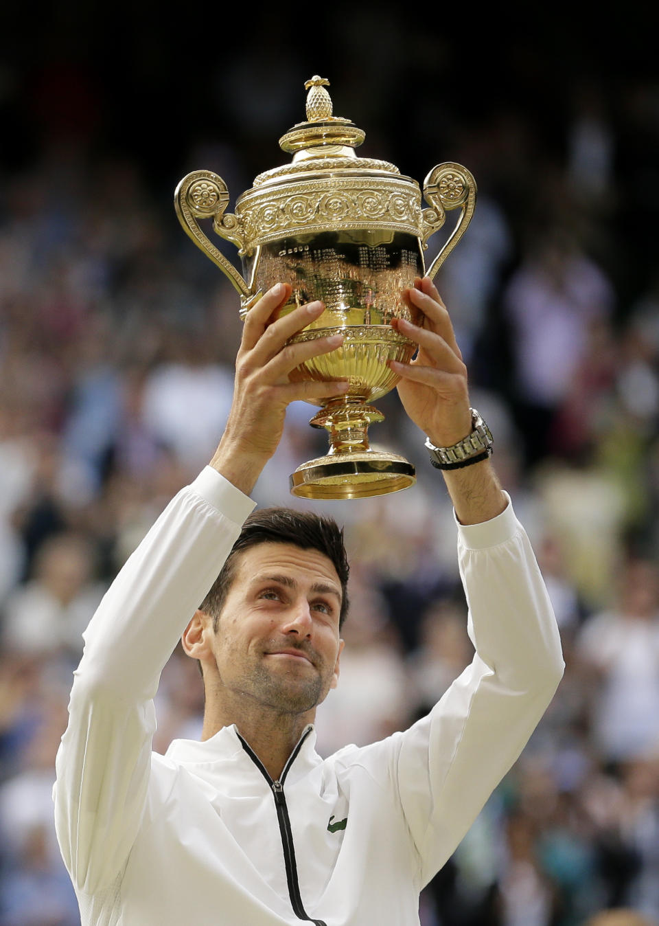 Serbia's Novak Djokovic lifts the trophy after defeating Switzerland's Roger Federer in the men's singles final match of the Wimbledon Tennis Championships in London, Sunday, July 14, 2019. (AP Photo/Tim Ireland)