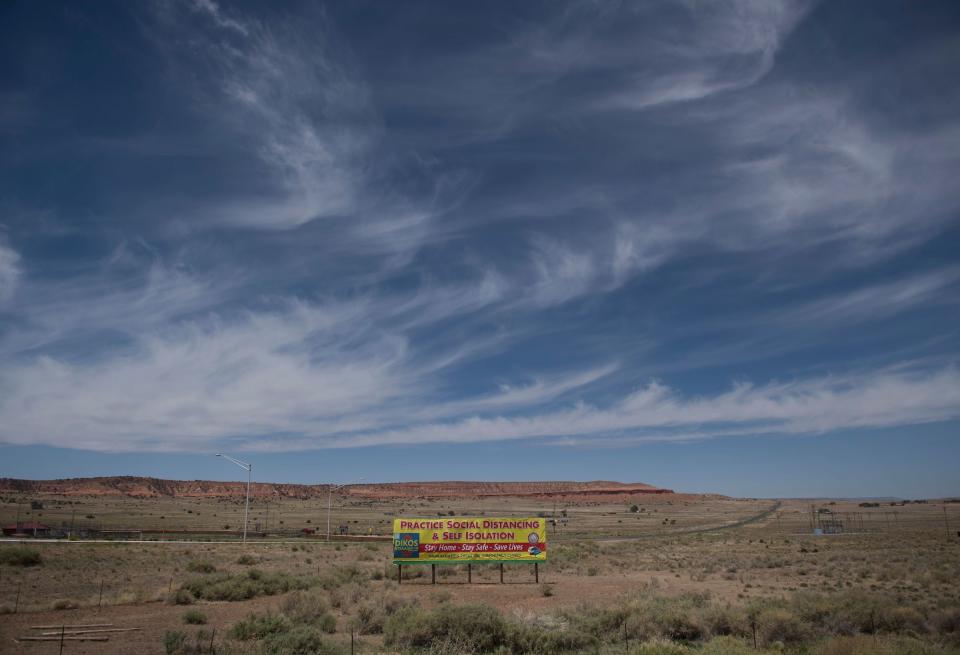 A sign promoting social distancing sits near the Navajo Nation town of Chinle during the 57 hour curfew imposed to try to stop the spread of the Covid-19 virus through the Navajo Nation, in Arizona on May 23, 2020. | Mark Ralston—AFP/Getty Images