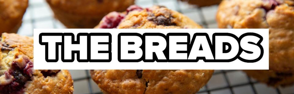 Freshly baked muffins on a cooling rack with the words "THE BREADS" overlaid