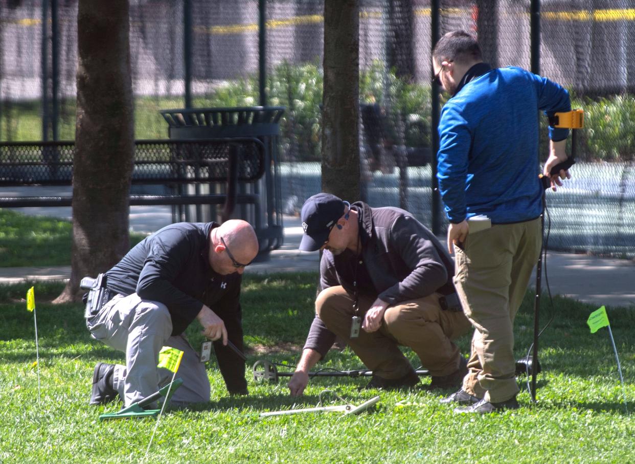Stockton Police detectives search Unity Park on Thursday, Apr. 13, 2023, the day after a Chavez High school student was killed in a shooting at the park.