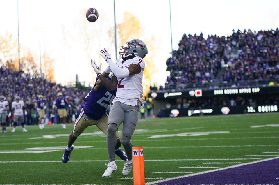 Washington State wide receiver Kyle Williams makes a touchdown catch in front of Washington cornerback Elijah Jackson during the first half of an NCAA college football game Saturday, Nov. 25, 2023, in Seattle. (AP Photo/Lindsey Wasson)