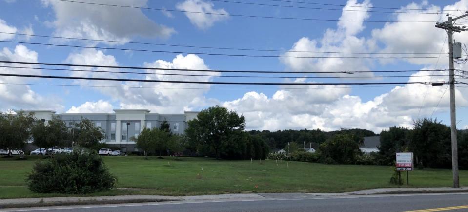 Developers are proposing to build a new shopping center on this acre of land in front of the Hampton Inn on Post Road in Wells, Maine.