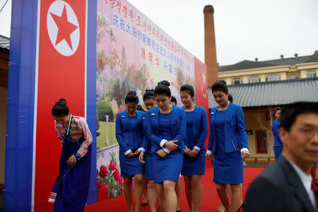 North Koreans attend the opening of a new cultural exhibition ahead of the celebrations marking the founding president Kim Il Sung's 105th birthday in Dandong, Liaoning province, China, April 14, 2017. REUTERS/Aly Song