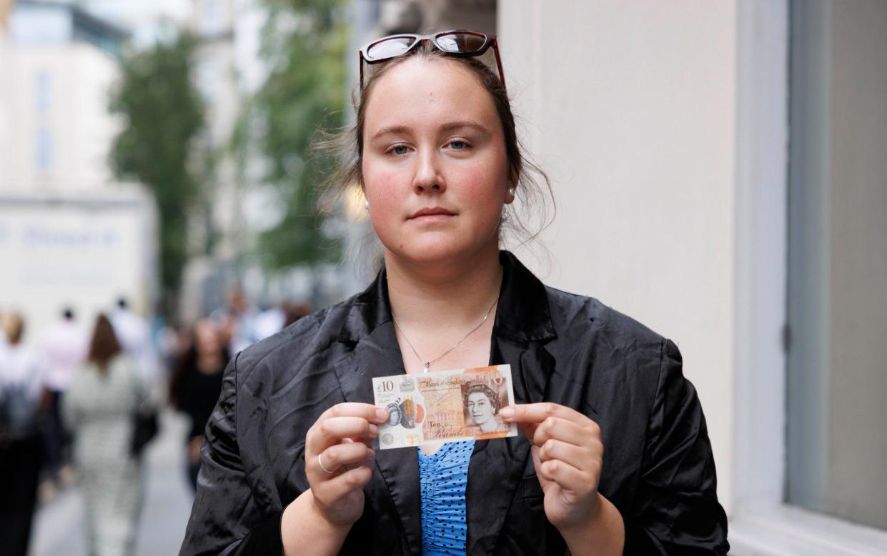 Madeleine holds up a £10 note at a Joe & The Juice