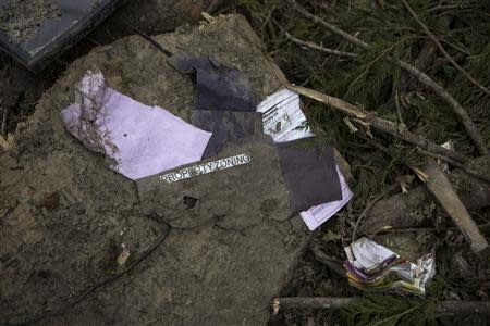 Property zoning paperwork lies in a debris field left by a mudslide in Oso, Washington, April 3, 2014. REUTERS/Max Whittaker