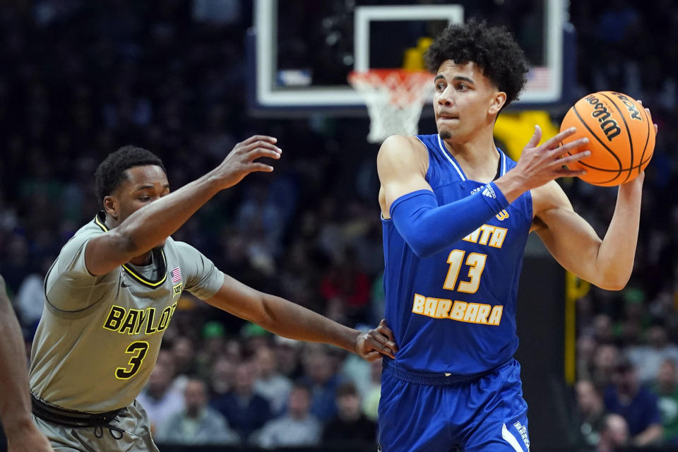 UC Santa Barbara guard Ajay Mitchell, right, looks to pass as Baylor guard Dale Bonner defends in the first half of a first-round college basketball game in the men's NCAA Tournament Friday, March 17, 2023, in Denver. (AP Photo/John Leyba)