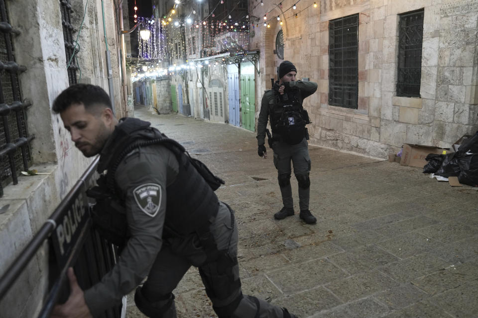 Israeli paramilitary Border Police close a path leading to the Al-Aqsa Mosque compound after shots were fired in the Old City of Jerusalem during the Muslim holy month of Ramadan, Saturday, April 1, 2023. (AP Photo/ Mahmoud Illean)