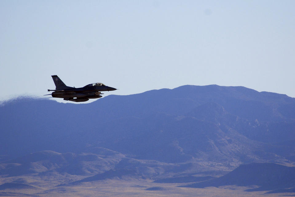 In this March, 2017, photo supplied by Sandia National Laboratories, an F-16C makes a pass over Nevada's Tonopah Test Range after a March test of a mock nuclear weapon as part of a life extension program for the B61-12, near Tonopah, Nev. Scientists at Sandia National Laboratories are claiming success with the first in a new series of test flights that are part of an effort to upgrade one of the nuclear weapons that has been in the U.S. arsenal for decades. (John Salois/Sandia National Laboratories via AP)