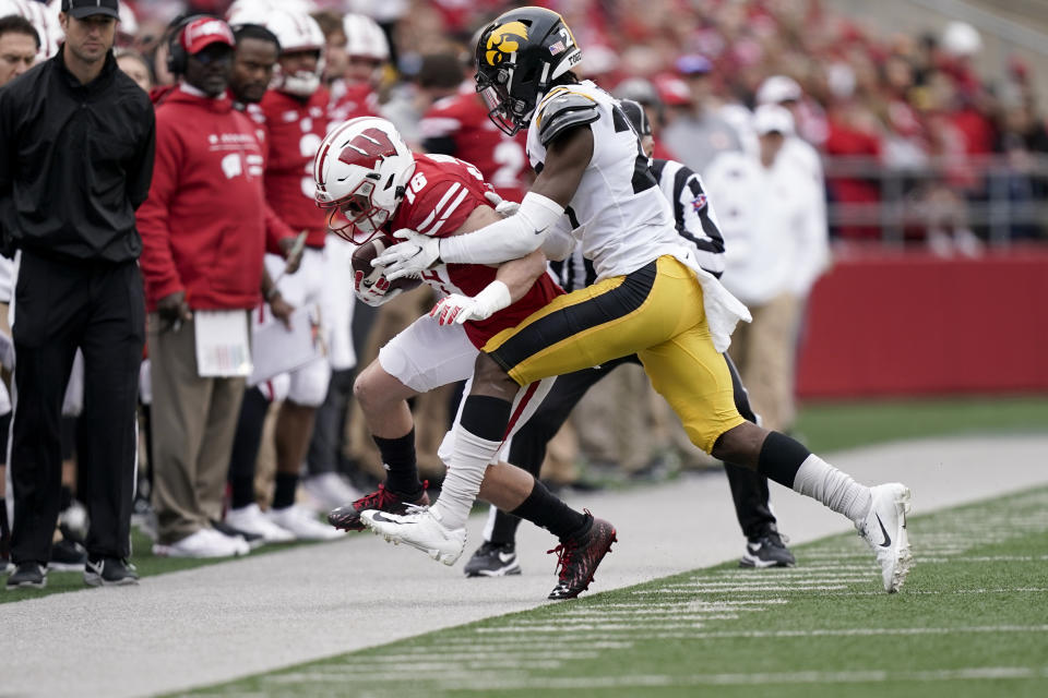 Iowa defensive back Jermari Harris (27) pushes Wisconsin wide receiver Jack Dunn (16) out of bounds after a reception in the first half of an NCAA college football game Saturday, Oct. 30, 2021, in Madison, Wis. (AP Photo/Andy Manis)