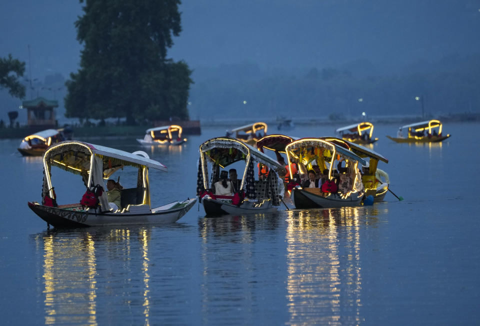 Delegates from the Group of 20 nations attending a tourism meeting enjoy boat ride at the Dal Lake in Srinagar, Indian controlled Kashmir, Monday, May 22, 2023. The meeting condemned by China and Pakistan is the first significant international event in Kashmir since New Delhi stripped the Muslim-majority region of semi-autonomy in 2019. (AP Photo/Mukhtar Khan)