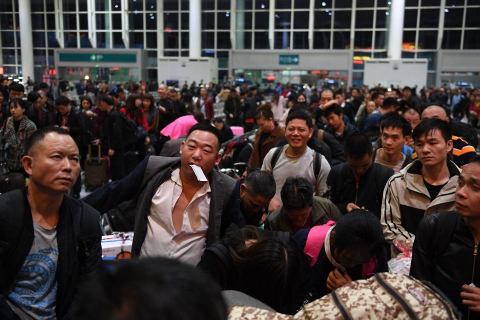 Passengers wait to board train K4526 at Shenzhen East Railway Station in Shenzhen, south China's Guangdong Province, Jan. 9, 2020.