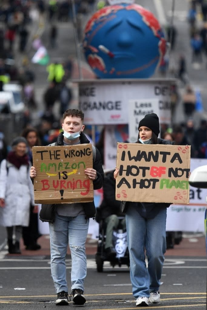 young adults holding signs at the protest