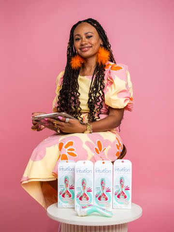 <p>Schick Intuition</p> Reyna Noriega posing with her Schick Intuition razors.