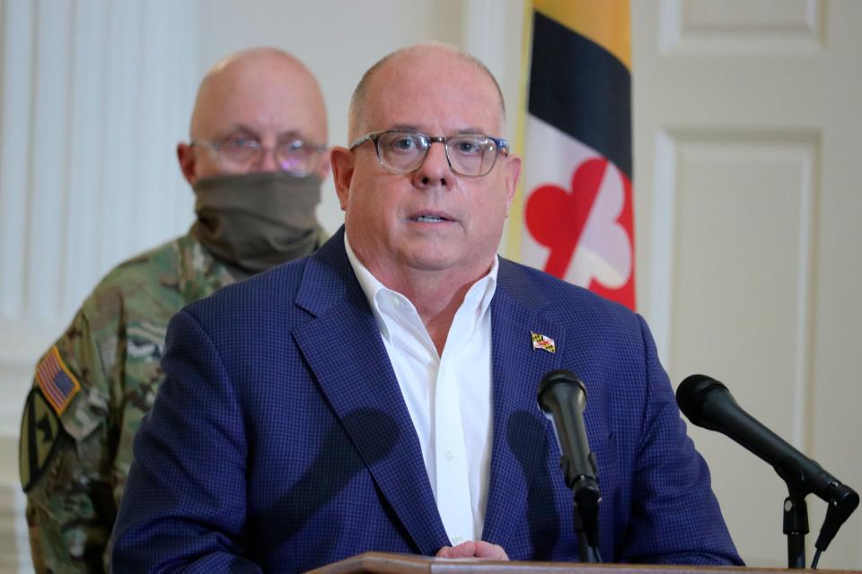 Maryland Gov. Larry Hogan announces that all nursing homes and assisted-living facilities in the state must conduct universal coronavirus testing of all residents and staff, whether they have symptoms or not, during a news conference on Wednesday, April 29, 2020, in Annapolis, Md. Col. Eric Allely, the state surgeon of the Maryland National Guard, is standing behind the governor. Allely has been named a compliance officer to see that nursing homes comply with state law.