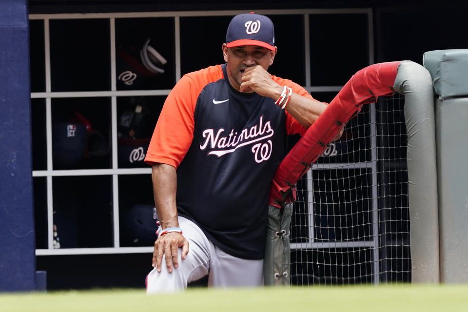 Washington Nationals manager Dave Martinez (4) watches from the dugout as his team plays the Atlanta Braves in a baseball game Thursday, June 3, 2021, in Atlanta. (AP Photo/John Bazemore)