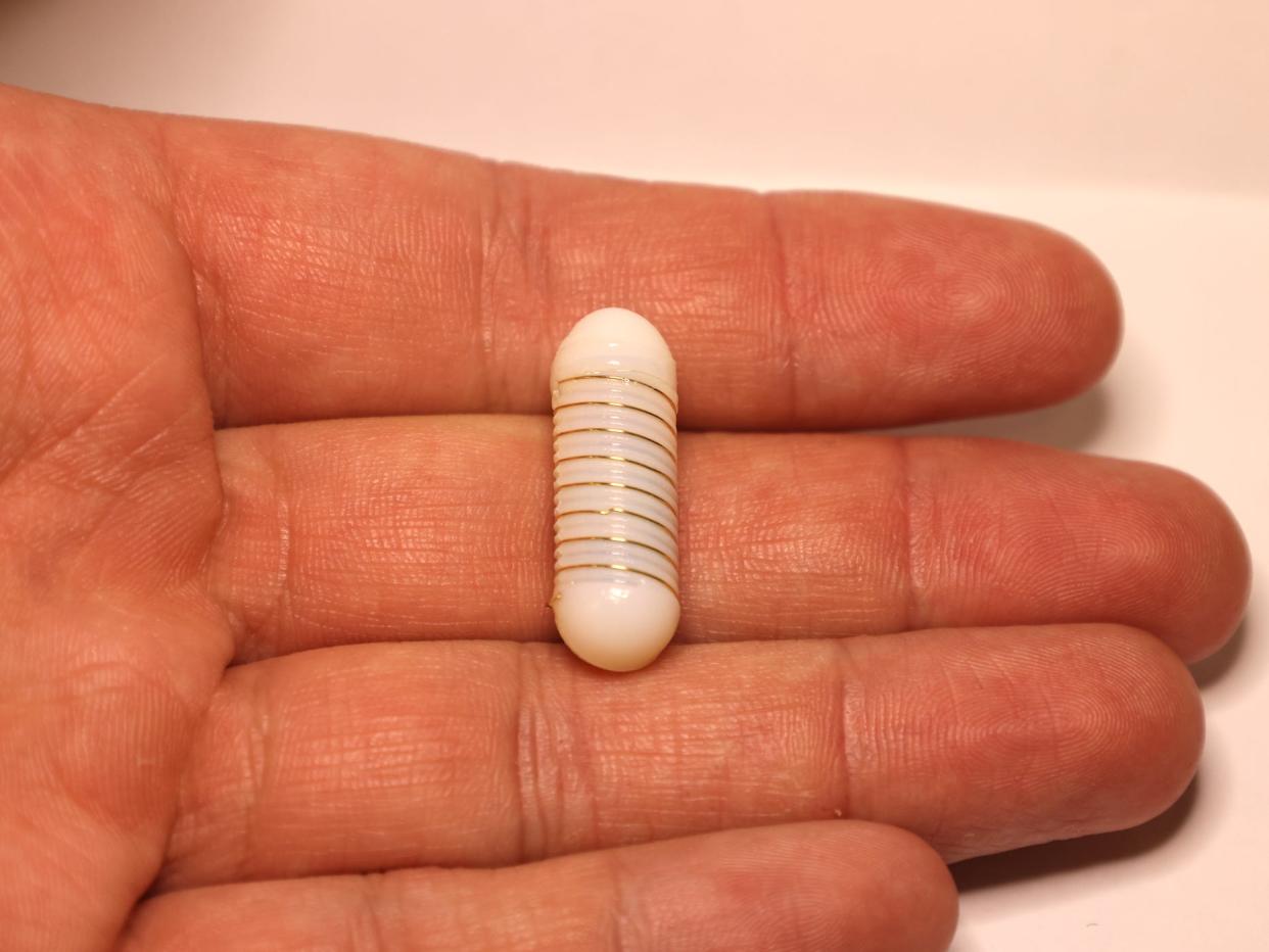 pill with electric coil wrapped around outside