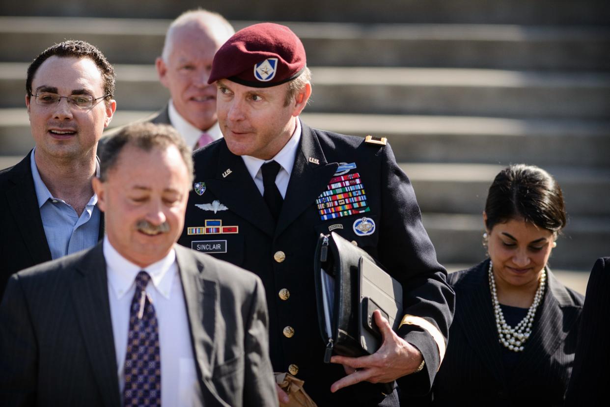 Brig. Gen. Jeffrey Sinclair, center, along with members of his defense team leave the courthouse after sentencing at Fort Bragg, N.C., Thursday, March 20, 2014.