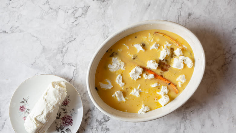 carrots in baking dish with egg mixture and goat cheese