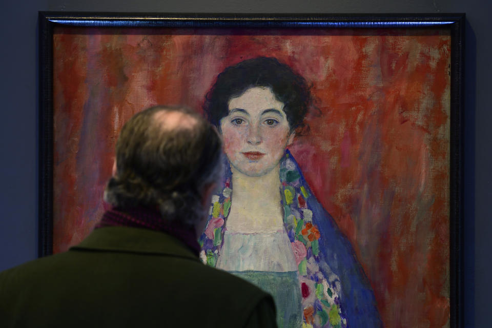 A man looks at the painting 'Portrait of Fräulein Lieser' by Austrian painter Gustav Klimt prior to an auction, in Vienna, Wednesday, April 24, 2024. A portrait of a young woman by Gustav Klimt that was long believed to be lost has been sold at an auction in Vienna for 30 million euros ($32 million). The Austrian modernist artist started work on the “Portrait of Fräulein Lieser” in 1917, the year before he died, and it is one of his last works. (AP Photo/Christian Bruna)