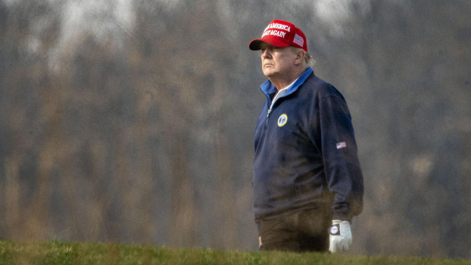 President Trump golfs at Trump National Golf Club earlier this month. His delay in signing the COVID-19 relief bill could interrupt benefits for many Americans.