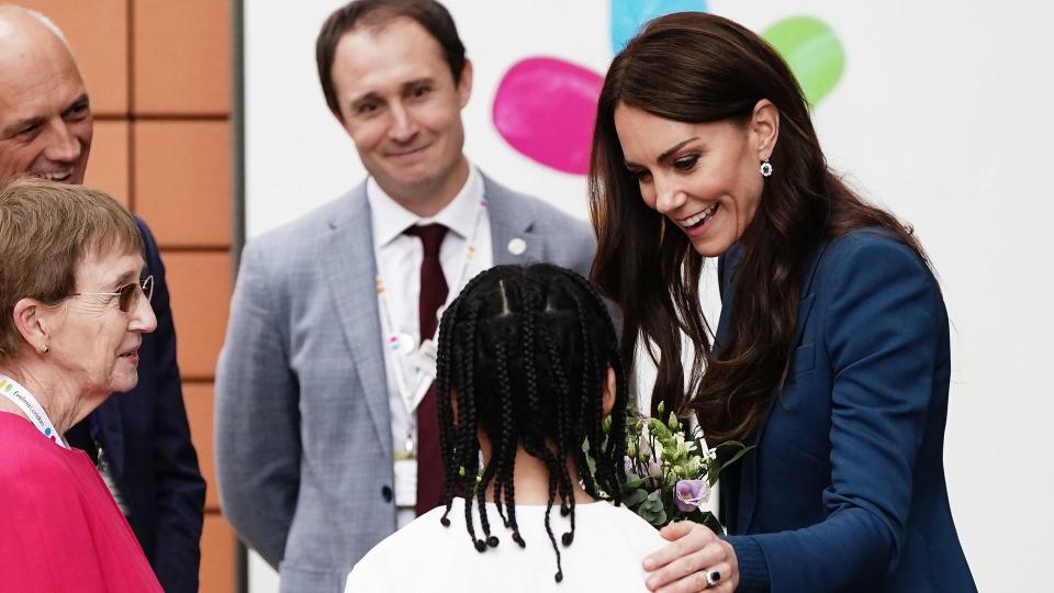 woman receiving flowers from child 