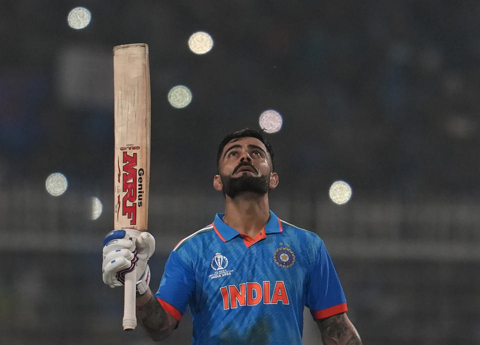 India's Virat Kohli looks skywards as he celebrates scoring a century during the ICC Men's Cricket World Cup match between India and South Africa in Kolkata, India, Sunday, Nov. 5, 2023. (AP Photo/Altaf Qadri)