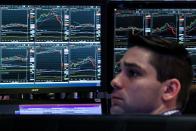 FILE PHOTO: Traders work on the floor of the NYSE in New York