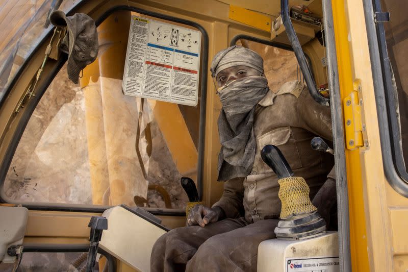 Ligen Eliyas, an excavator operator for Border Roads Organisation, takes a break as he works on an under construction highway in the Ladakh region