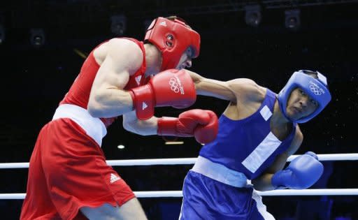 Thomas Stalker of Great Britain (in red) defends against Munkh-Erdene Uranchimeg of Mongolia (in blue) during the Light Welterweight boxing quarterfinals of the 2012 London Olympic Games at the ExCel Arena in London. Uranchimeg advanced to the semi-finals on a close 23-22 points decision