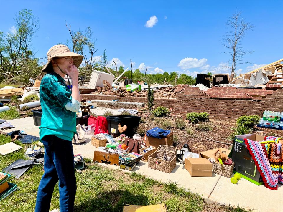 Valerie Bernhart looks among what remains of her Blackburn Lane home, which was destroyed during Wednesday night's tornado while she and her husband, John, were trapped inside.