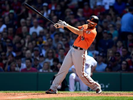 Apr 13, 2019; Boston, MA, USA; Baltimore Orioles first baseman Chris Davis (19) hits an RBI double against the Boston Red Sox during the fifth inning at Fenway Park. Mandatory Credit: Brian Fluharty-USA TODAY Sports