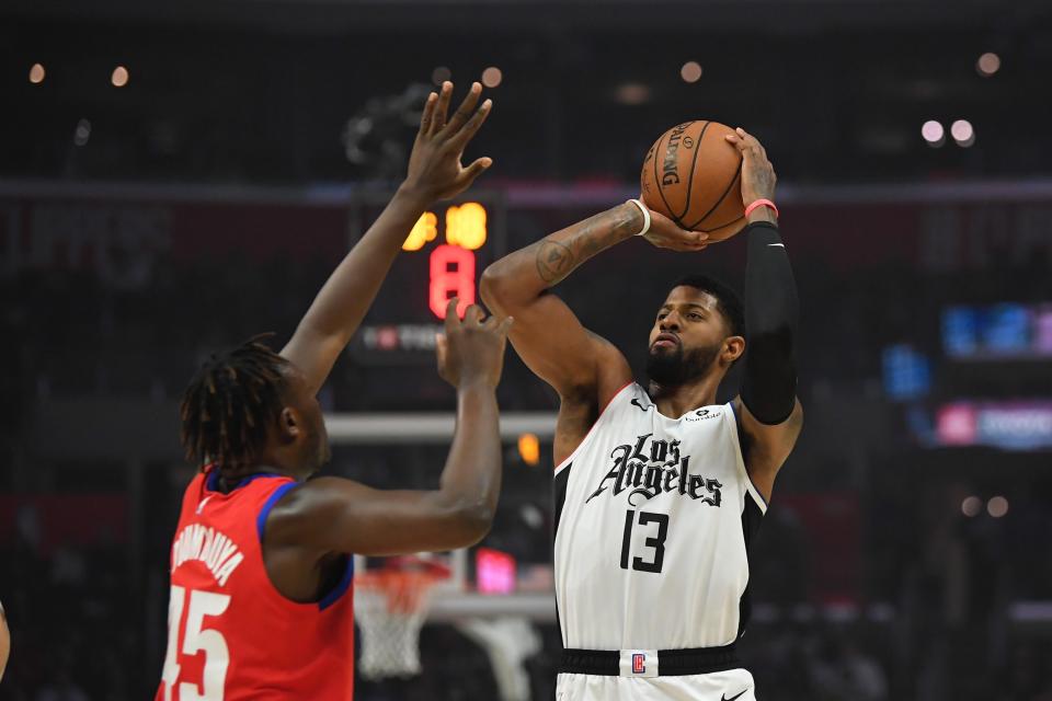 Los Angeles Clippers forward Paul George, right, shoots as Detroit Pistons forward Sekou Doumbouya defends during the first half of an NBA basketball game Thursday, Jan. 2, 2020, in Los Angeles. (AP Photo/Mark J. Terrill)