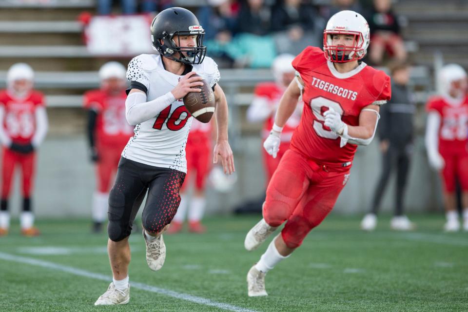 Lowell's Carter Harris (10) scrambles outside the pocket during the Class 2A OSAA state championship at Hillsboro Stadium on Saturday, Nov. 25, 2023, in Hillsboro, Ore.