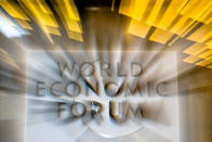 In this photo taken with a long shutter, the sign of the World Economic Forum is displayed at the entrance of the at annual meeting of the forum in Davos, Switzerland, Tuesday, Jan. 22, 2019. (AP Photo/Markus Schreiber)