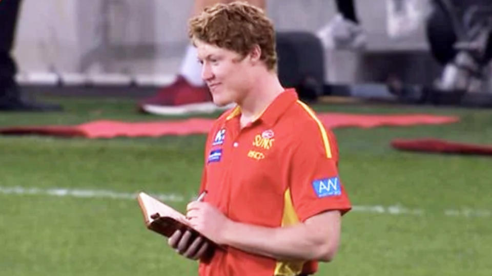 Suns youngster Matt Rowell takes notes on the sideline.