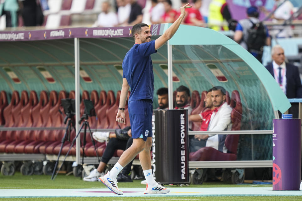 England's Conor Coady, waves to fans before the start of the World Cup group B soccer match between England and Iran at the Khalifa International Stadium, in Doha, Qatar, Monday, Nov. 21, 2022. (AP Photo/Martin Meissner)