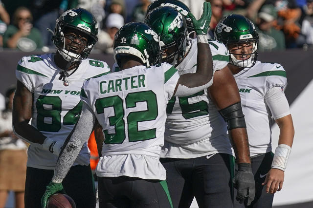 New York Jets running back Michael Carter (32) warms up before taking on  the Miami Dolphins during an NFL football game Sunday, Oct. 9, 2022, in  East Rutherford, N.J. (AP Photo/Adam Hunger