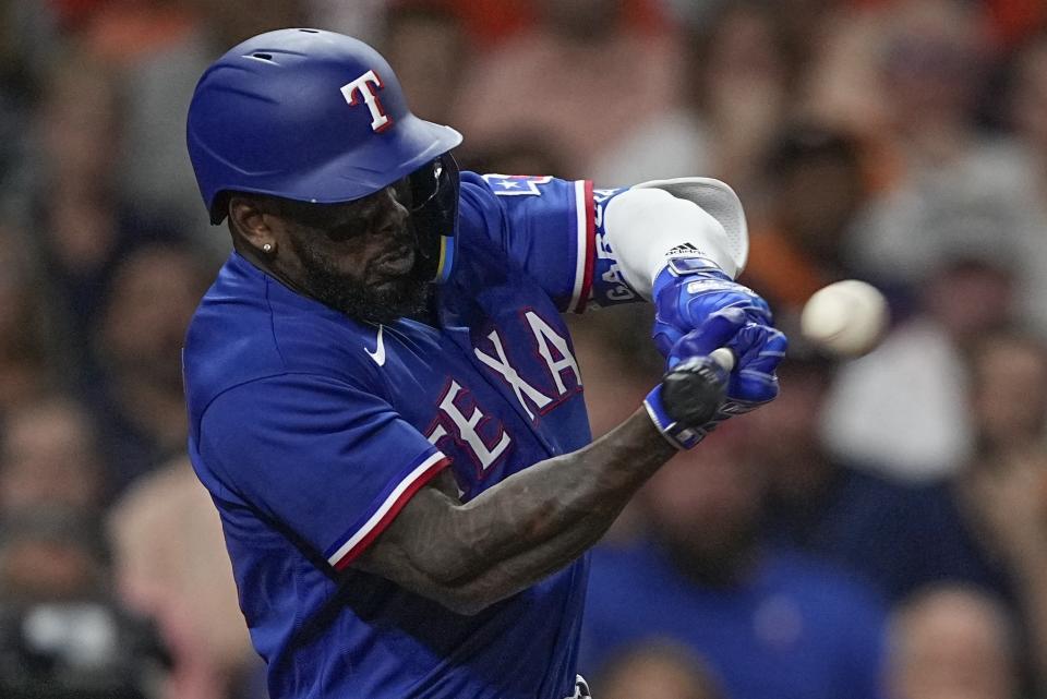 Texas Rangers' Adolis Garcia hits an RBI single during the first inning of Game 6 of the baseball AL Championship Series against the Houston Astros Monday, Oct. 23, 2023, in Houston. (AP Photo/David J. Phillip)