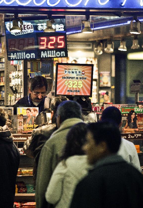 People wait in line to purchase lottery on Friday, Nov. 23, 2012 in New York. The jackpot for Powerball's weekend drawing has climbed to $325 million, the fourth-largest in the game's history. Powerball organizers say this is the first run-up to a large jackpot that's fallen over a major holiday. (AP Photo/Bebeto Matthews)