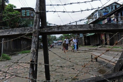 Muslim Rohingyas walk towards a barbed wire fence around a ghetto created after violence wracked Rakhine state in June. Three people have been killed in a fresh outbreak of communal violence between Muslim Rohingya and Buddhists in Myanmar's western Rakhine state, a local official said Tuesday