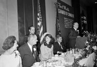 First lady Jacqueline Kennedy is all smiles as she attends a breakfast held by the Chamber of Commerce in Fort Worth, Texas, on Nov. 22, 1963. Seated at the dais, from left, are, Lady Bird Johnson, Vice President Lyndon B. Johnson, Mrs. Kennedy and President John F. Kennedy. The man at podium is unidentified. (Photo: Ferd Kaufman/AP)