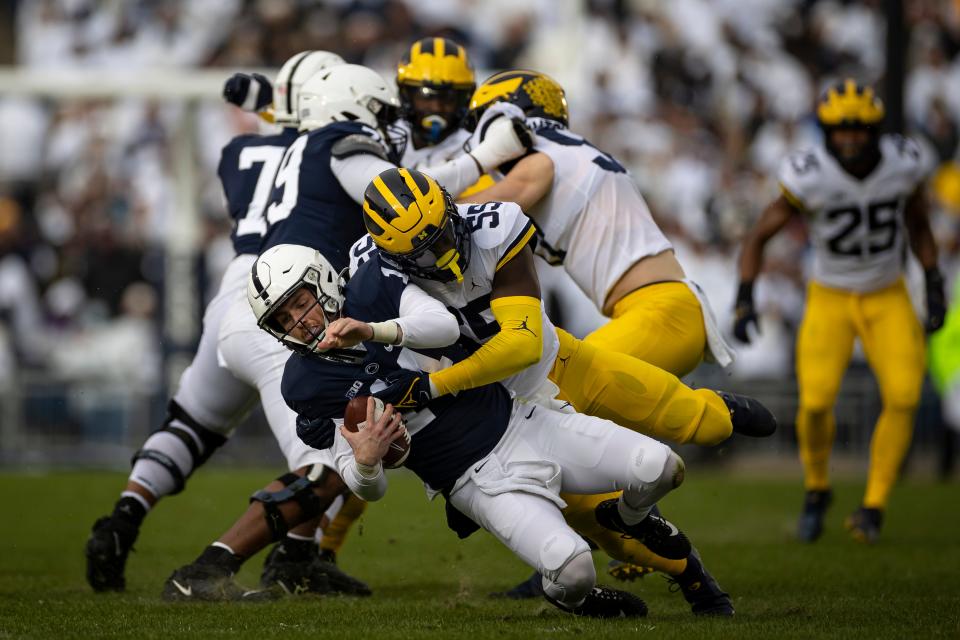 Penn State quarterback Sean Clifford is sacked by Michigan defensive lineman David Ojabo during the first half on Saturday, Nov. 13, 2021, in State College, Pennsylvania.