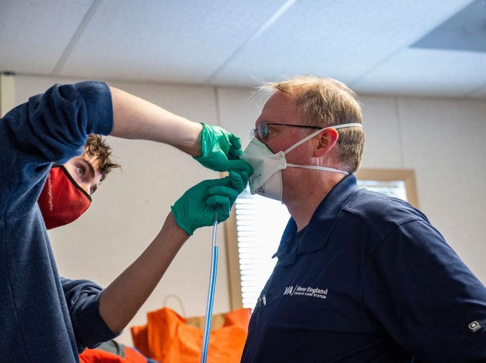 A medical worker fit tests an N95 mask to a hospital worker at the US Department of Veterans Affairs Boston in West Roxbury, Massachusetts on January 11, 2022.